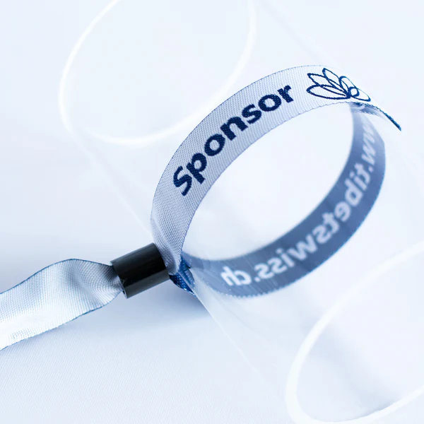 Silberfarbenes gewebtes Einlassband mit Kunststoffverschluss auf Glaszylinder