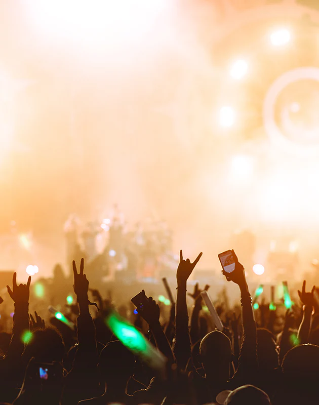 Publikumshände als Silhouetten vor hellem Bühnenlicht