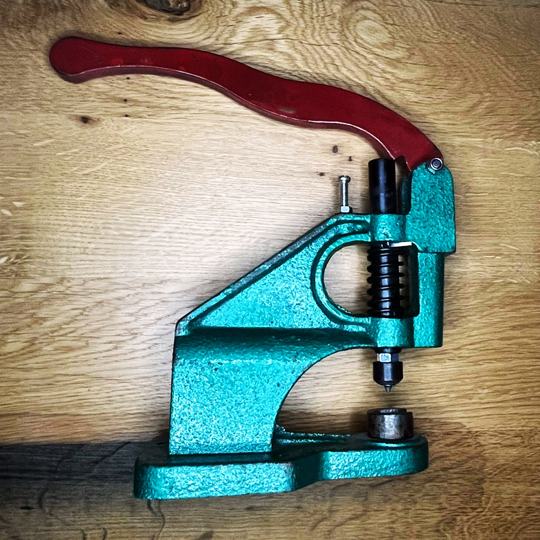 grüne Tischpresse liegt auf einem Tisch